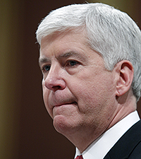Michigan Gov. Rick Snyder pauses as he delivers his State of the State address to a joint session of the House and Senate, Tuesday, Jan. 19, 2016, at the state Capitol in Lansing, Mich. With the water crisis gripping Flint threatening to overshadow nearly everything else he has accomplished, the Republican governor pledged a fix Tuesday night during his annual State of the State speech. (AP Photo/Al Goldis)