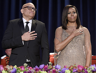 Larry Wilmore, left, guest host from Comedy Central, center, and first lady Michelle Obama, right, listen to the National Anthem at the annual White House Correspondents' Association dinner at the Washington Hilton in Washington, Saturday, April 30, 2016. (AP Photo/Susan Walsh)