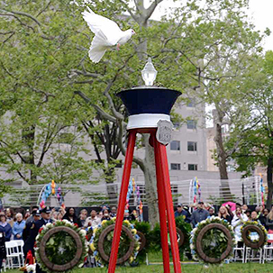 When doves fly….One of three doves takes flight today at Franklin Square Park at the close of the annual Police & Fire Living Flame Memorial Service to honor more than 500 police officers and firefighters who sacrificed their lives in service over the years.  (Photo by Tony Webb, City of Philadelphia/ Office of the City Representative)