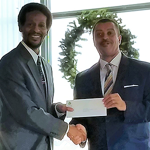 Ken Scott, President of the Beech Companies, photographed with a representative from the Uptown Theater (grant recipient). 