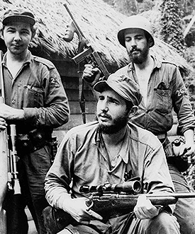 In this March 14, 1957 file photo, Fidel Castro, the young anti-Batista guerrilla leader, center, is seen with his brother Raul Castro, left, and Camilo Cienfuegos, right, while operating in the Mountains of Eastern Cuba. Cuban President Raul Castro has announced the death of his brother Fidel Castro at age 90 on Cuban state media on Friday, Nov. 25, 2016. (AP Photo/Andrew St. George, File)